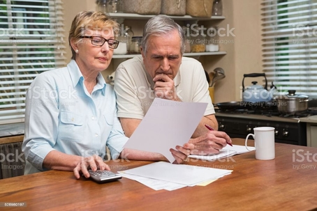 Couple sitting at table looking at a document